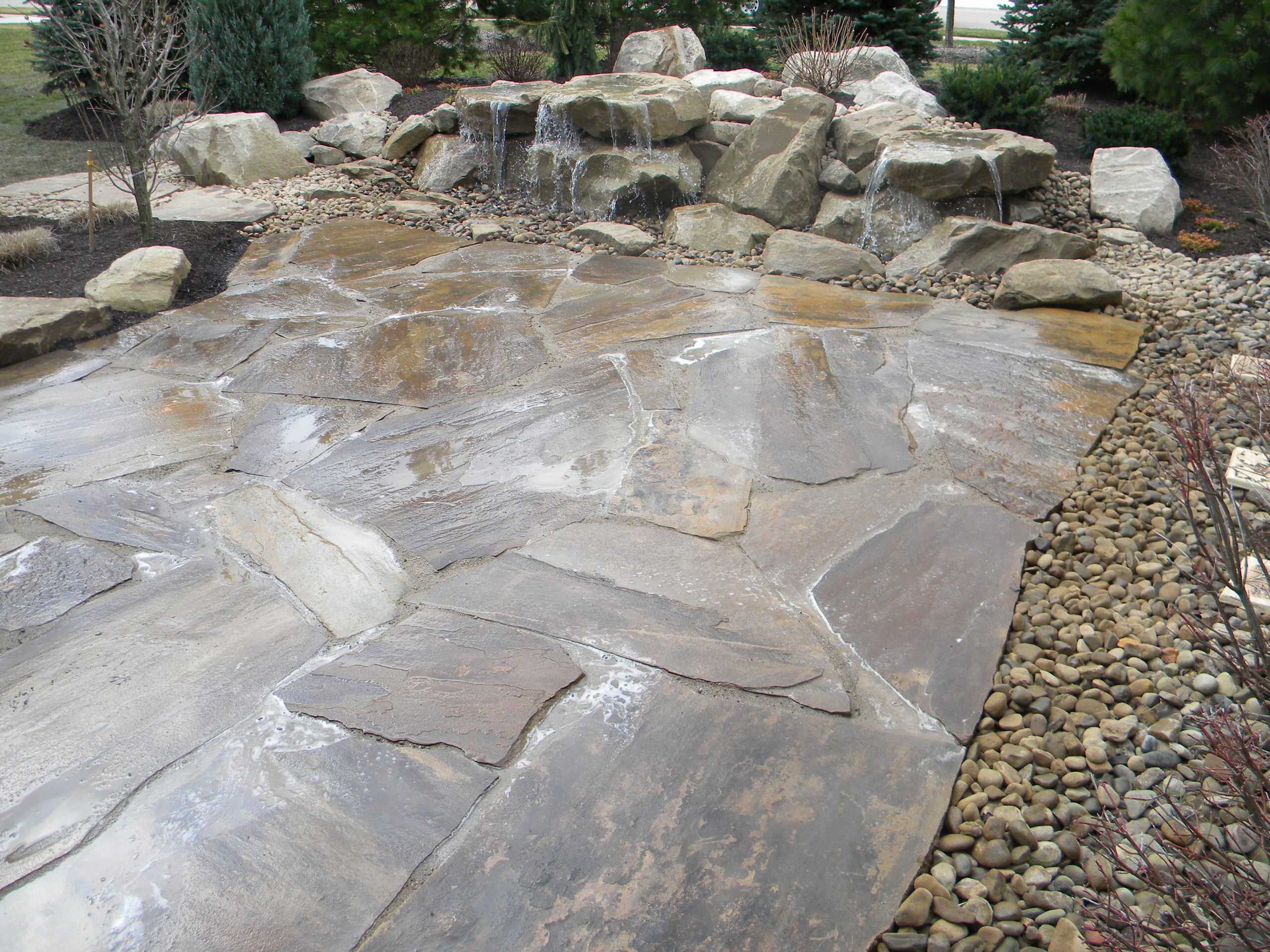 Carved stone water feature pondless and stone patio