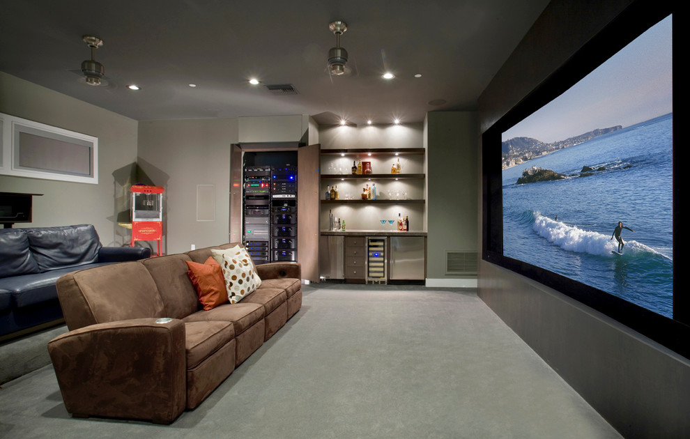 Inspiration for a large modern enclosed home theatre in Los Angeles with grey walls, carpet, a projector screen and grey floor.