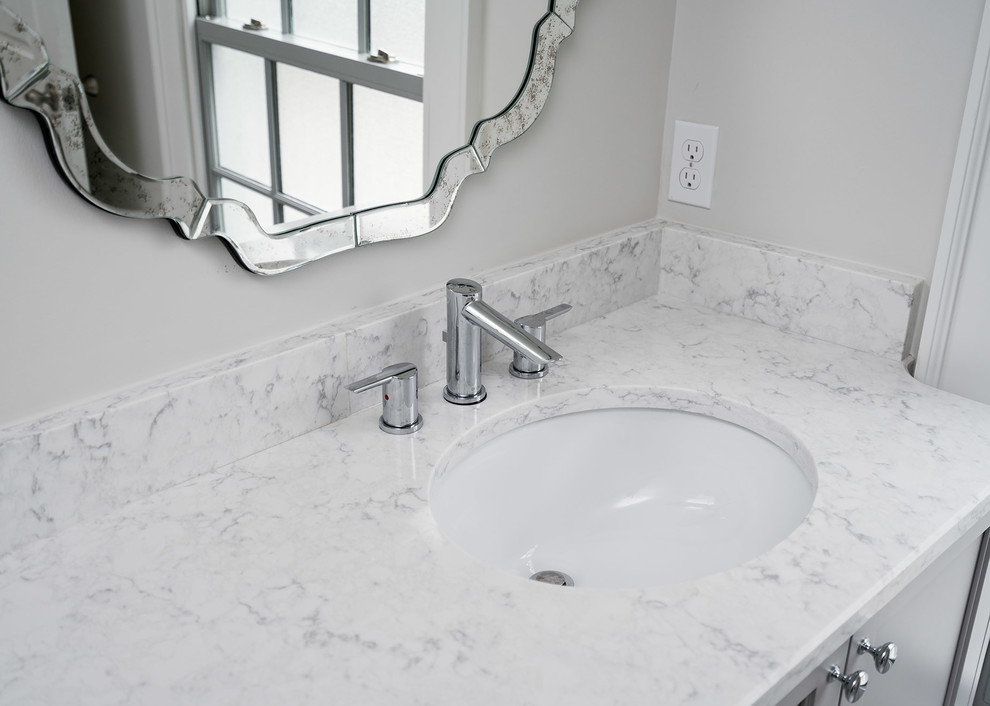Small transitional kids' gray tile and ceramic tile ceramic tile and white floor home design photo with shaker cabinets, blue cabinets, a two-piece toilet, gray walls, an undermount sink, quartz countertops and a hinged shower door