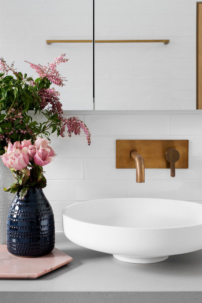 Photo of a large contemporary master bathroom in Melbourne with flat-panel cabinets, medium wood cabinets, a freestanding tub, an open shower, a two-piece toilet, gray tile, white tile, subway tile, grey walls, ceramic floors, a vessel sink, concrete benchtops, blue floor, an open shower and grey benchtops.