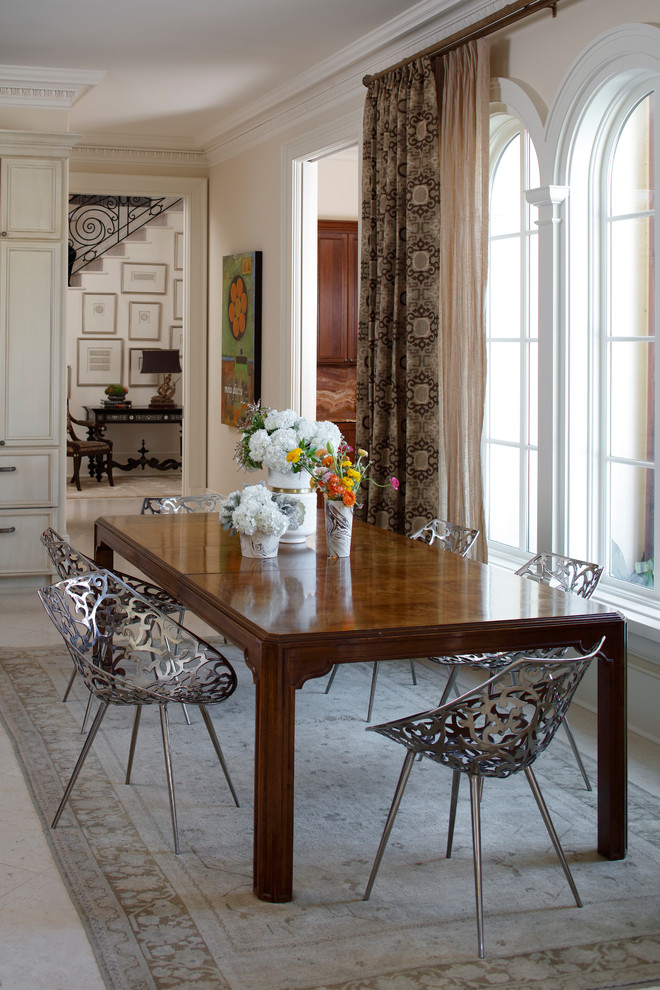This is an example of a transitional dining room in Miami with beige walls and white floor.