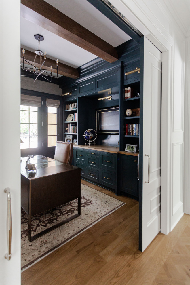 Grand Haven Custom Home - The home office is used daily for this executive who works remotely. Everything was thoughtfully designed for the needs - a drink refrigerator and file drawers are built into the wall cabinetry; various lighting options, grass cloth wallpaper, swivel chairs and a wall-mounted tv