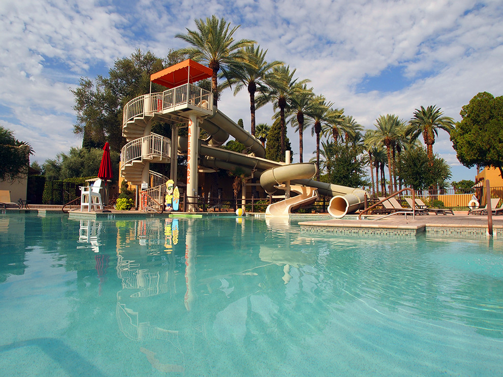 Large southwest backyard custom-shaped infinity water slide photo in Phoenix