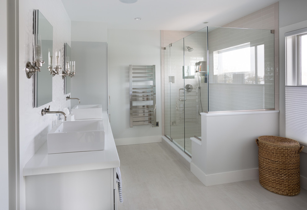 This is an example of a mid-sized contemporary master bathroom in New York with flat-panel cabinets, grey cabinets, a corner shower, gray tile, porcelain tile, white walls, porcelain floors, a vessel sink and glass benchtops.