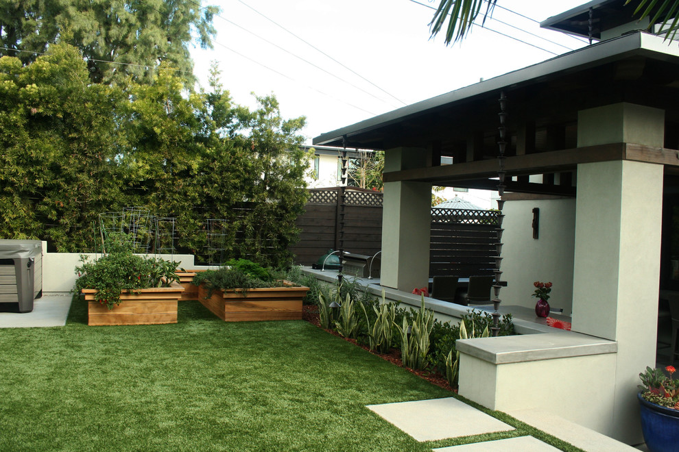 Inspiration for a small contemporary backyard partial sun formal garden for summer in San Diego with with raised garden bed and concrete pavers.