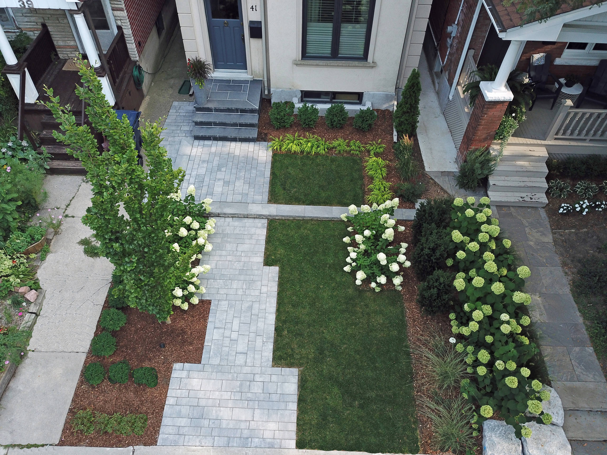 Inspiration for a mid-sized modern partial sun front yard concrete paver landscaping in Toronto for summer.