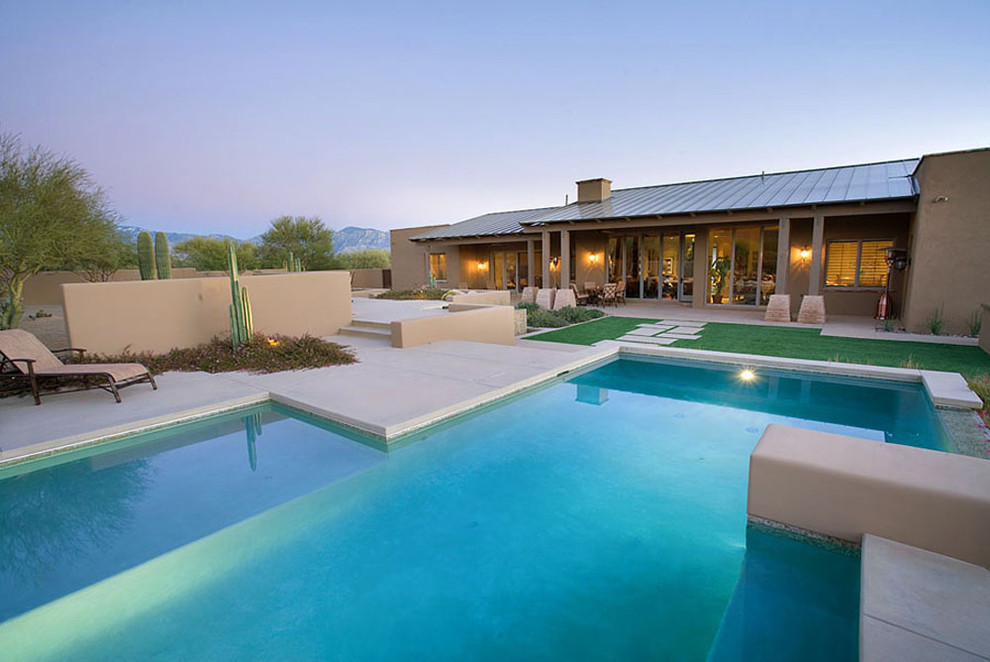 Photo of a large mediterranean backyard custom-shaped lap pool in Phoenix with concrete slab.