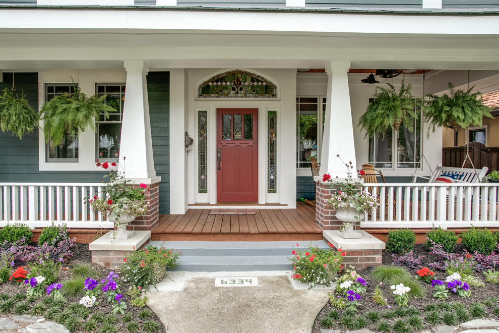 This is an example of a large arts and crafts front yard verandah in Dallas with decking and a roof extension.