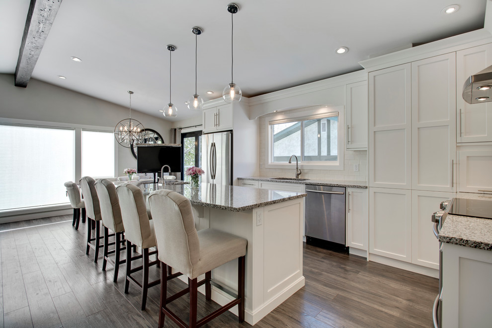 Example of a transitional home design design in Calgary