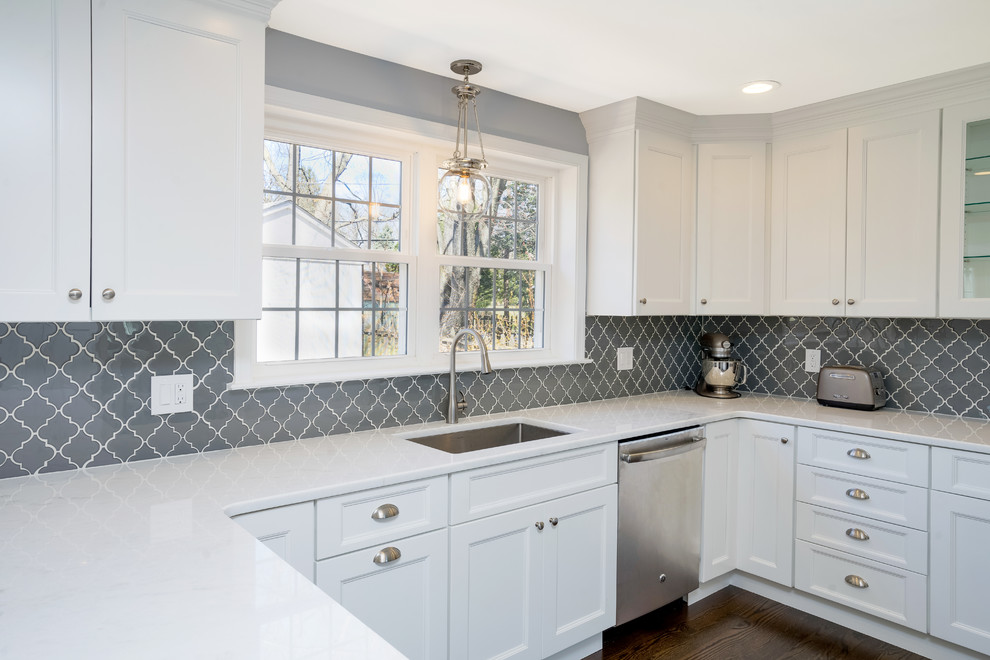 Inspiration for a transitional u-shaped eat-in kitchen in Philadelphia with an undermount sink, recessed-panel cabinets, white cabinets, quartzite benchtops, grey splashback, porcelain splashback, stainless steel appliances, dark hardwood floors and a peninsula.