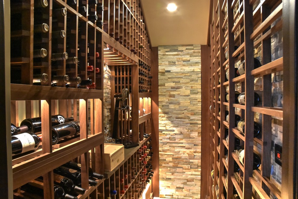 Photo of a mid-sized mediterranean wine cellar in San Diego with marble floors and display racks.
