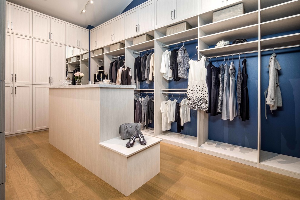 Design ideas for a large contemporary women's walk-in wardrobe in San Francisco with raised-panel cabinets, white cabinets, light hardwood floors and beige floor.