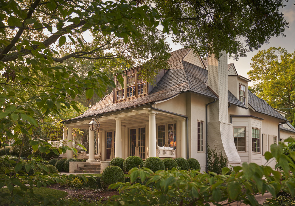 Inspiration for a transitional two-storey beige house exterior in Charlotte with a hip roof and a shingle roof.