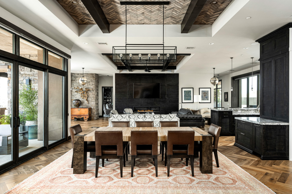 Inspiration for an expansive open plan dining in Phoenix with white walls, medium hardwood floors, a ribbon fireplace, a tile fireplace surround and beige floor.