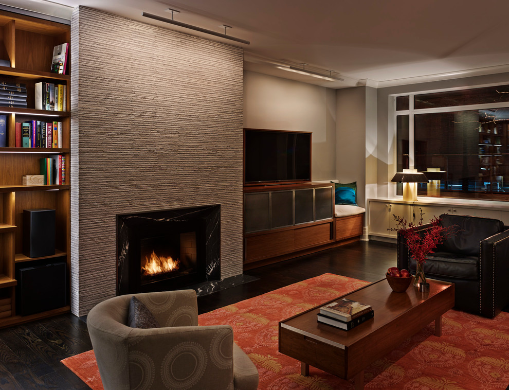 Inspiration for a large contemporary open concept family room in New York with beige walls, dark hardwood floors, a standard fireplace, a freestanding tv, a stone fireplace surround and brown floor.
