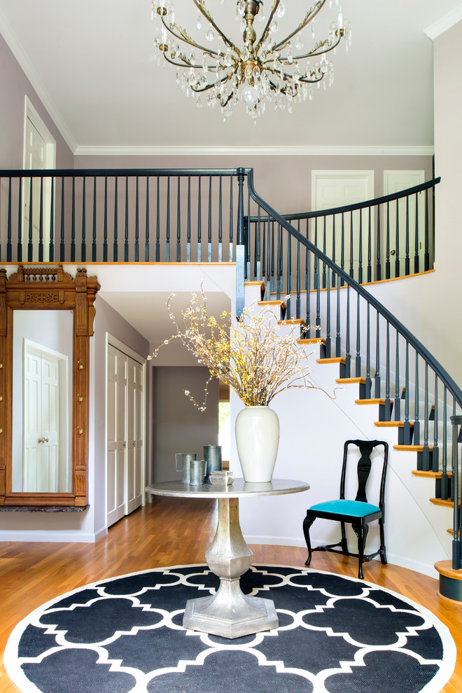 Design ideas for a large transitional foyer in New York with white walls and medium hardwood floors.