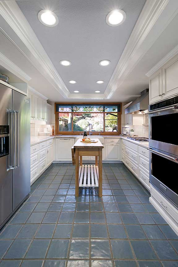 サンフランシスコにある広いトラディショナルスタイルのおしゃれなキッチン (エプロンフロントシンク、レイズドパネル扉のキャビネット、白いキャビネット、珪岩カウンター、白いキッチンパネル、セラミックタイルのキッチンパネル、セラミックタイルの床、青い床、白いキッチンカウンター、シルバーの調理設備) の写真