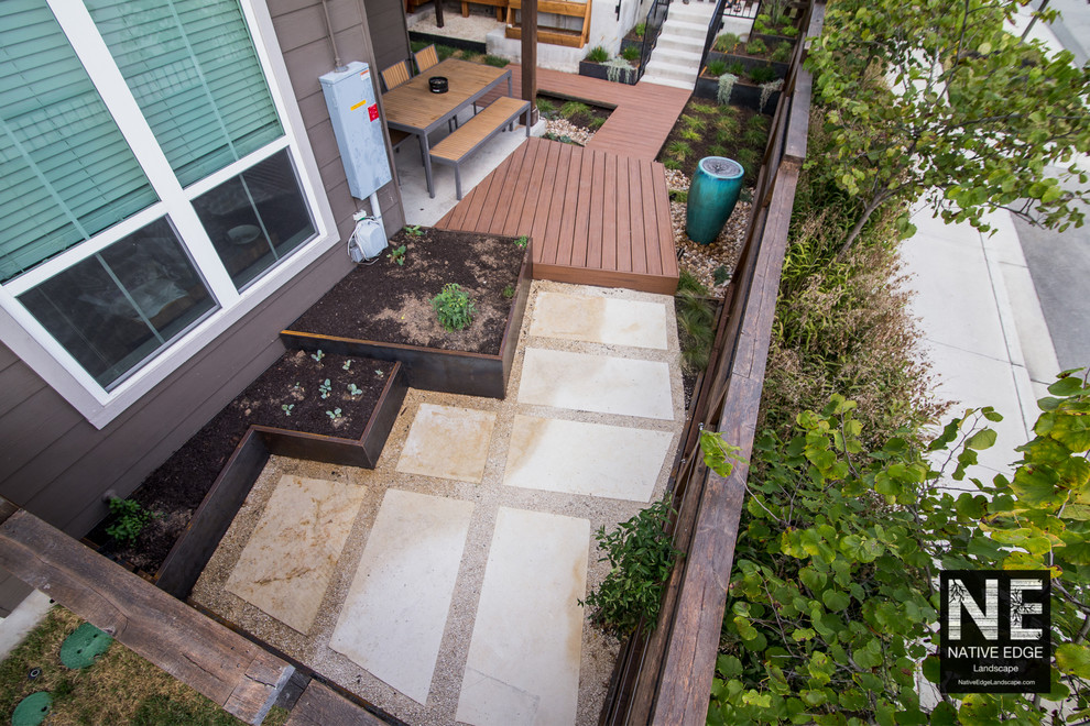 Small modern courtyard xeriscape in Austin with concrete pavers and a vegetable garden.
