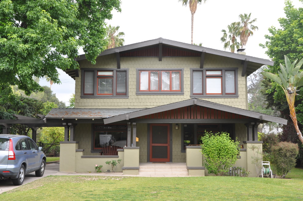 Design ideas for a large arts and crafts two-storey green exterior in Los Angeles with wood siding.