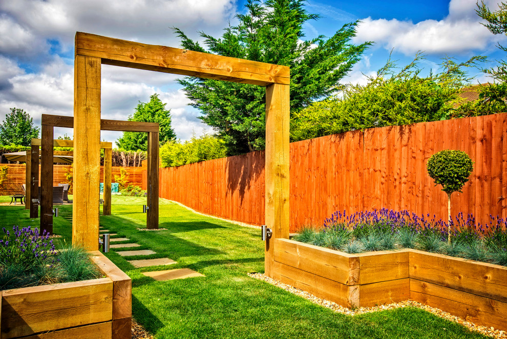 This is an example of a mid-sized contemporary backyard formal garden in Other with river rock.