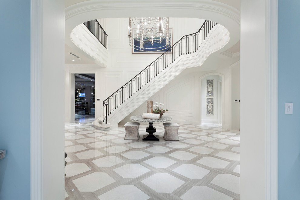Expansive contemporary foyer in Miami with marble floors and a double front door.