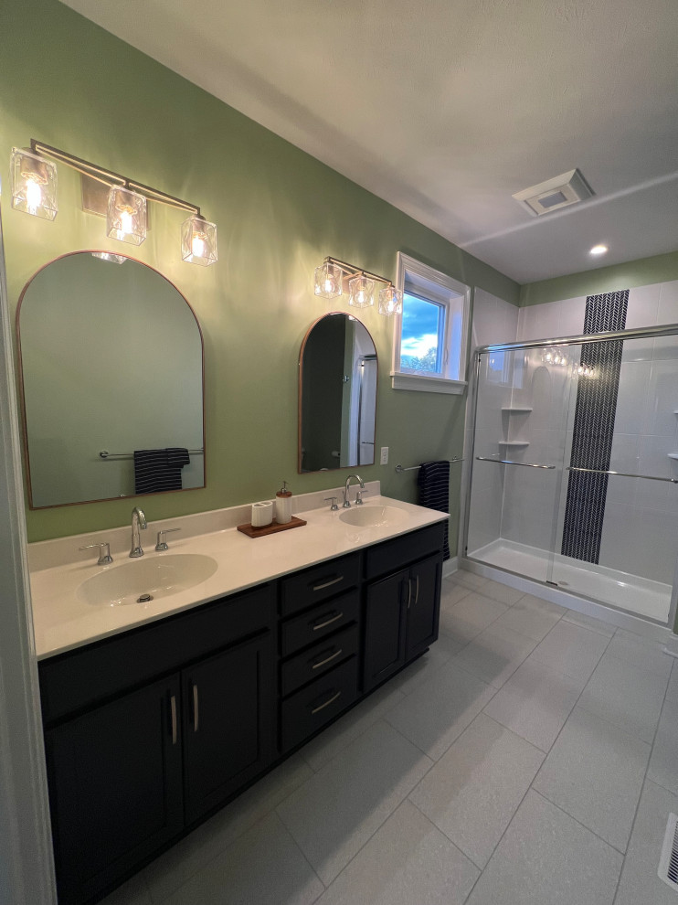 This is an example of a medium sized modern ensuite bathroom in New York with flat-panel cabinets, dark wood cabinets, an alcove shower, green walls, ceramic flooring, an integrated sink, laminate worktops, grey floors, a sliding door, white worktops, double sinks and a floating vanity unit.