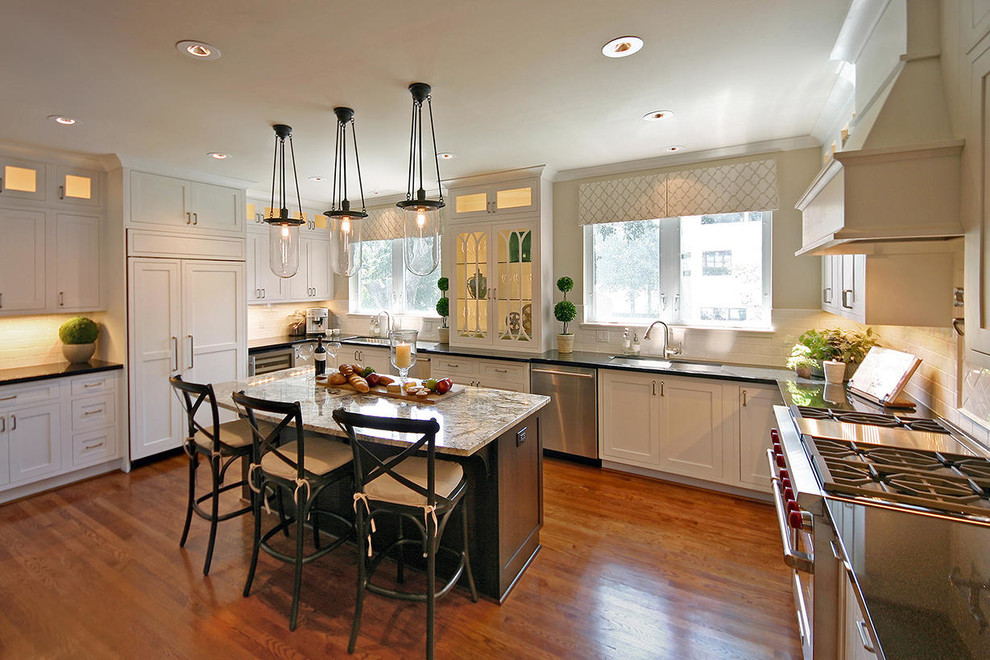 Example of a large transitional medium tone wood floor kitchen design in Houston with an undermount sink, recessed-panel cabinets and an island