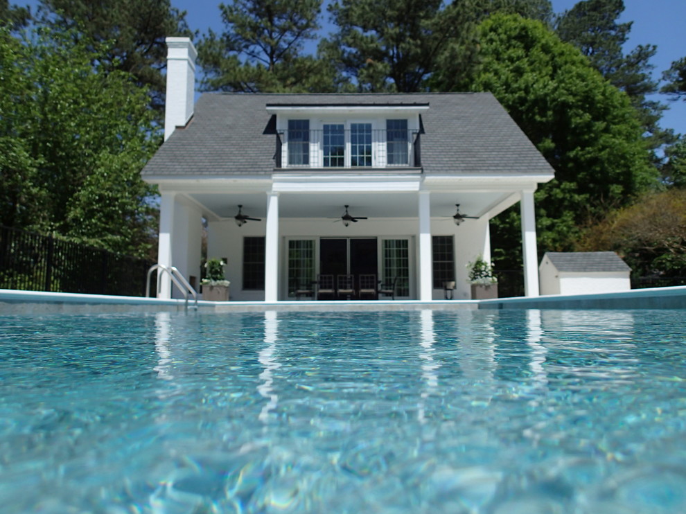 Example of a mid-sized transitional backyard rectangular pool design