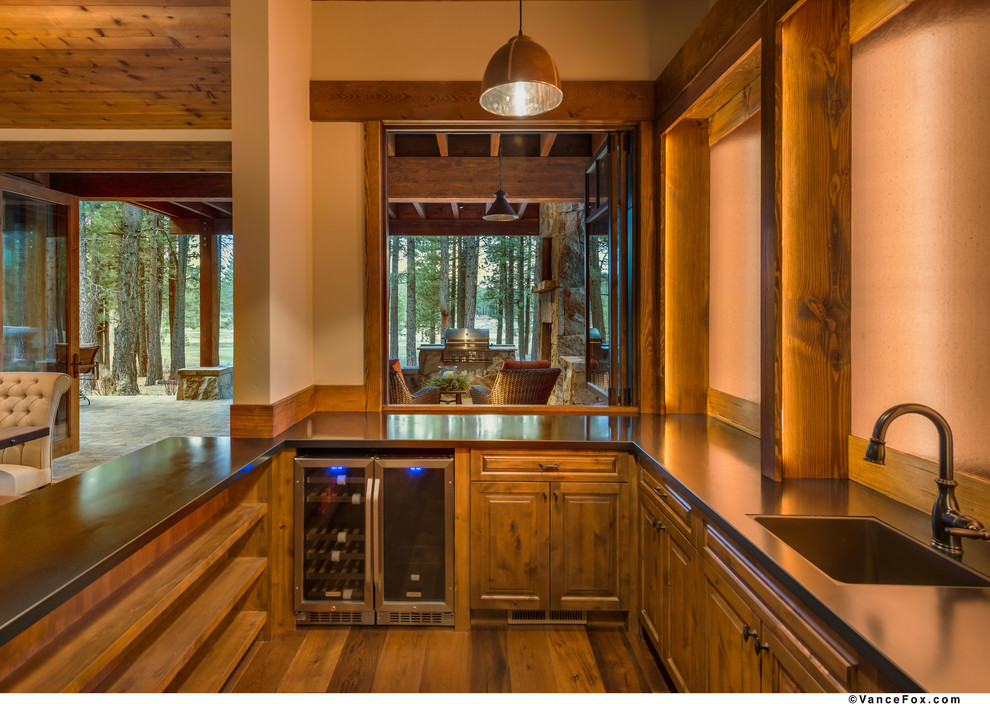Inspiration for a country u-shaped wet bar in Sacramento with stainless steel benchtops and dark hardwood floors.