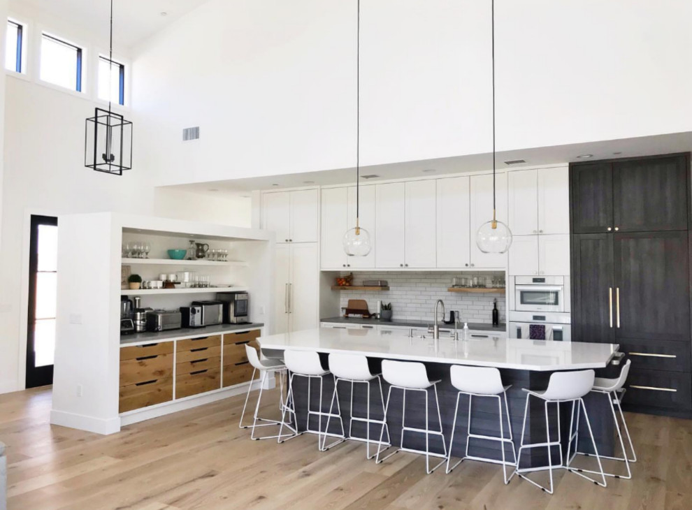This is an example of a contemporary l-shaped open plan kitchen in Los Angeles with with island.