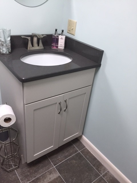 Photo of a small transitional 3/4 bathroom in Boston with shaker cabinets, grey cabinets, a two-piece toilet, gray tile, blue walls, porcelain floors, an undermount sink, granite benchtops, an alcove tub, a shower/bathtub combo and mosaic tile.