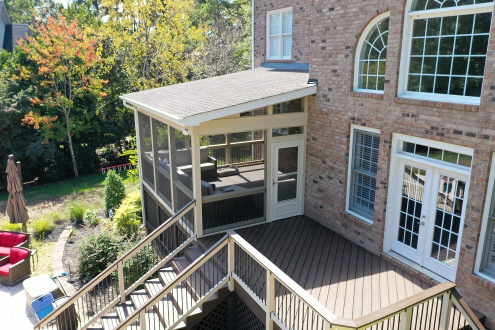 Example of a mid-sized backyard deck design in Charlotte with no cover