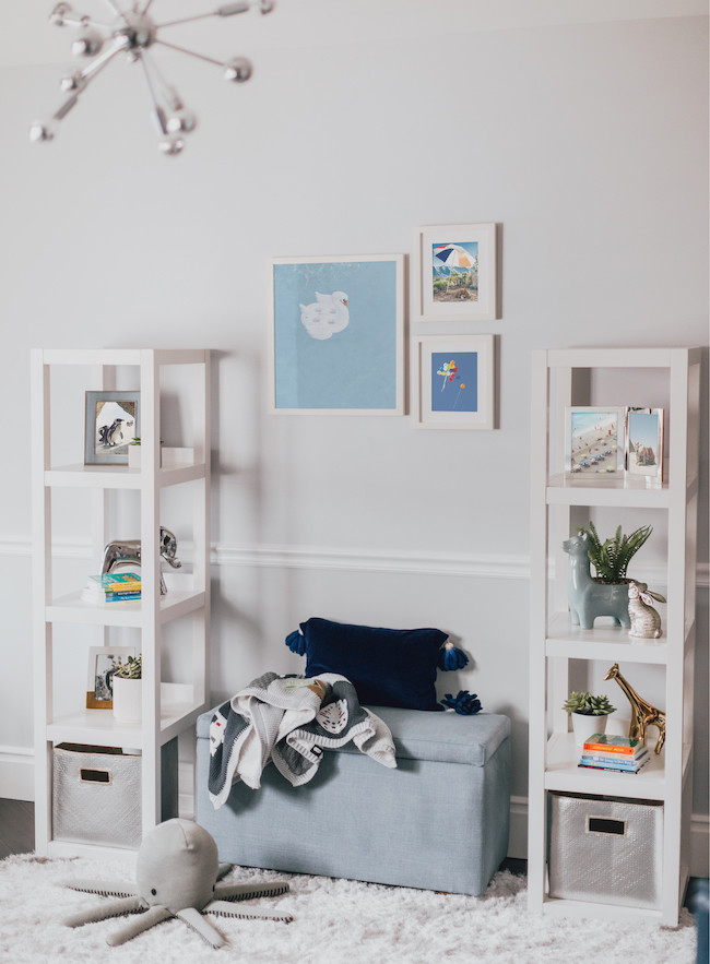 Design ideas for a mid-sized modern nursery for boys in Los Angeles with white walls, dark hardwood floors and white floor.