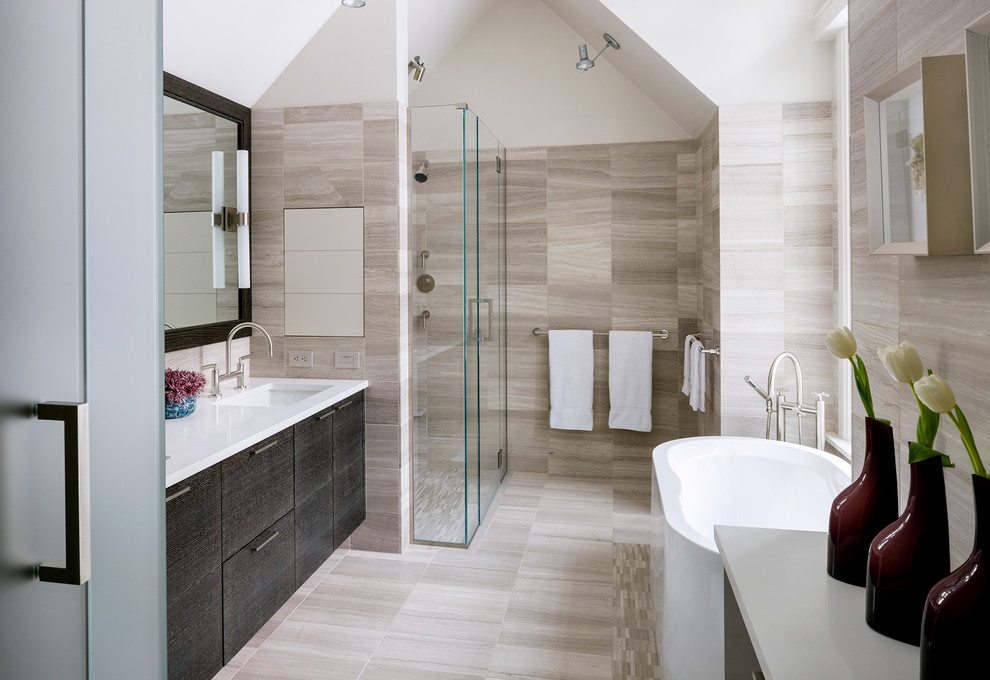Design ideas for a mid-sized contemporary master bathroom in Boston with flat-panel cabinets, dark wood cabinets, an alcove shower, beige tile, porcelain tile, white walls, light hardwood floors, marble benchtops, a freestanding tub, an undermount sink and a hinged shower door.