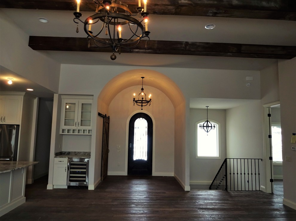Inspiration for a mid-sized rustic dark wood floor front door remodel with beige walls and a dark wood front door