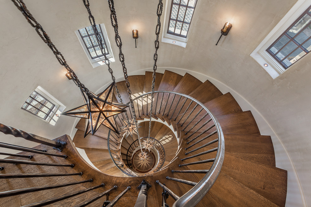 Inspiration for an expansive country wood spiral staircase in Other with wood risers.