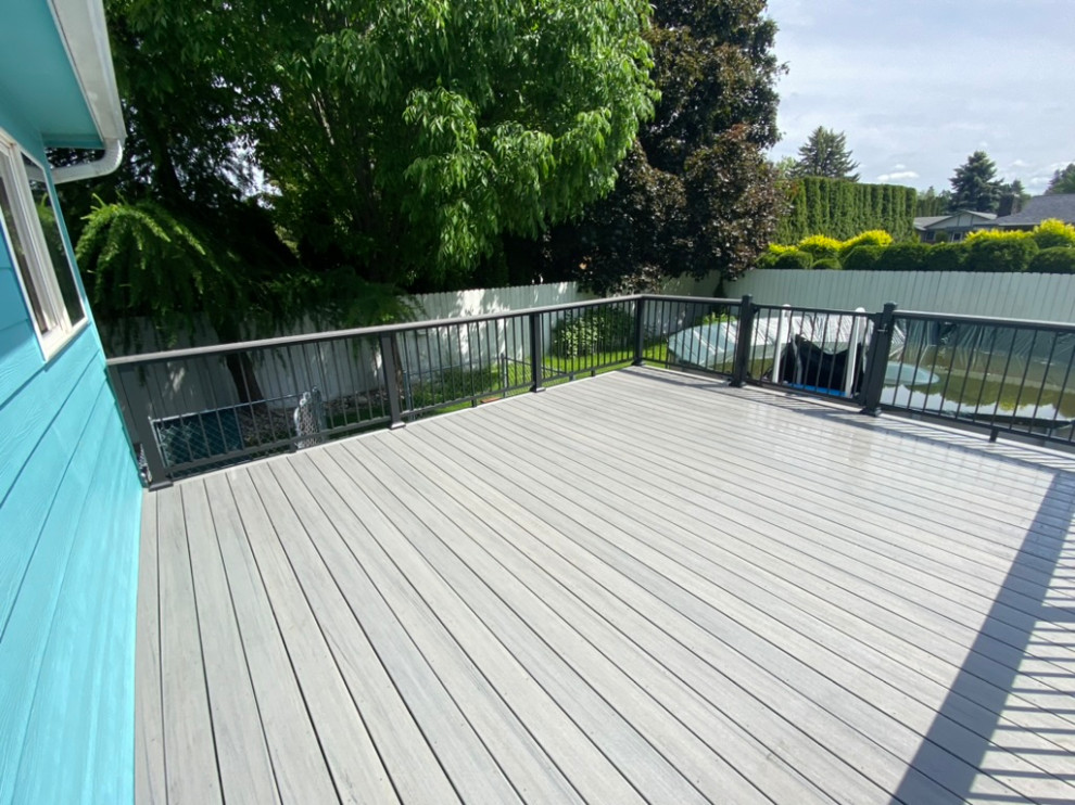 Deck - large backyard metal railing deck idea in Seattle