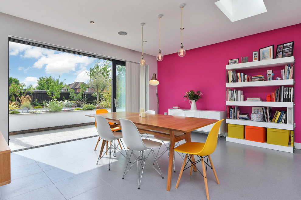 Design ideas for a mid-sized contemporary dining room in Other with pink walls and grey floor.