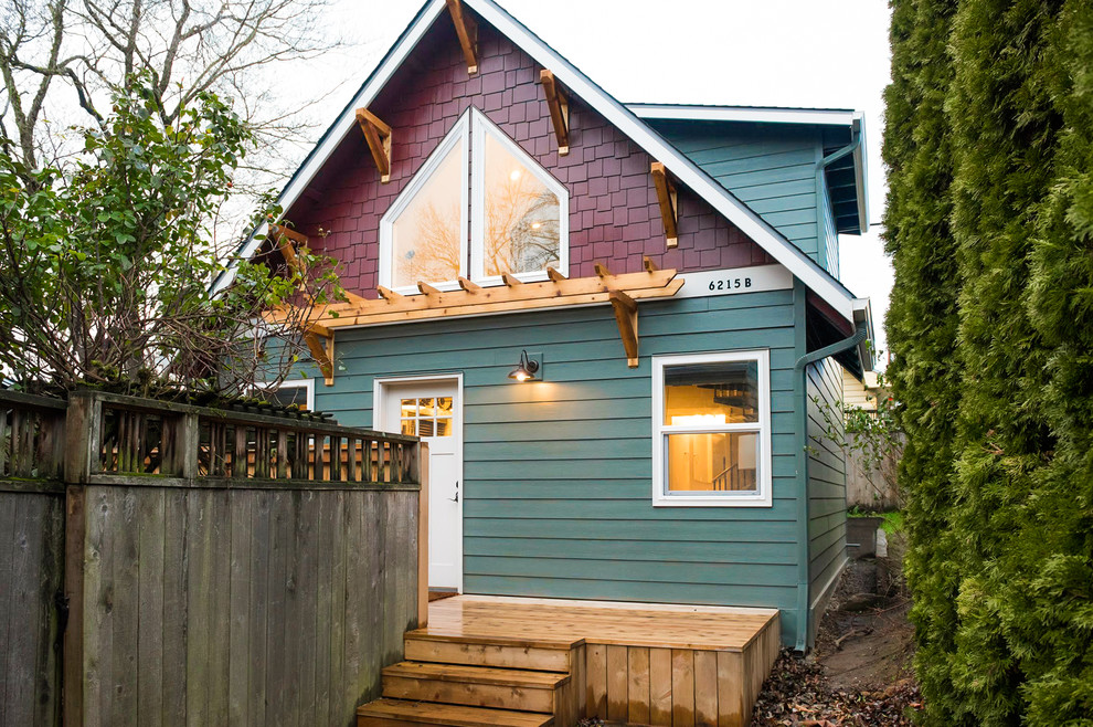Small traditional blue two-story wood exterior home idea in Portland