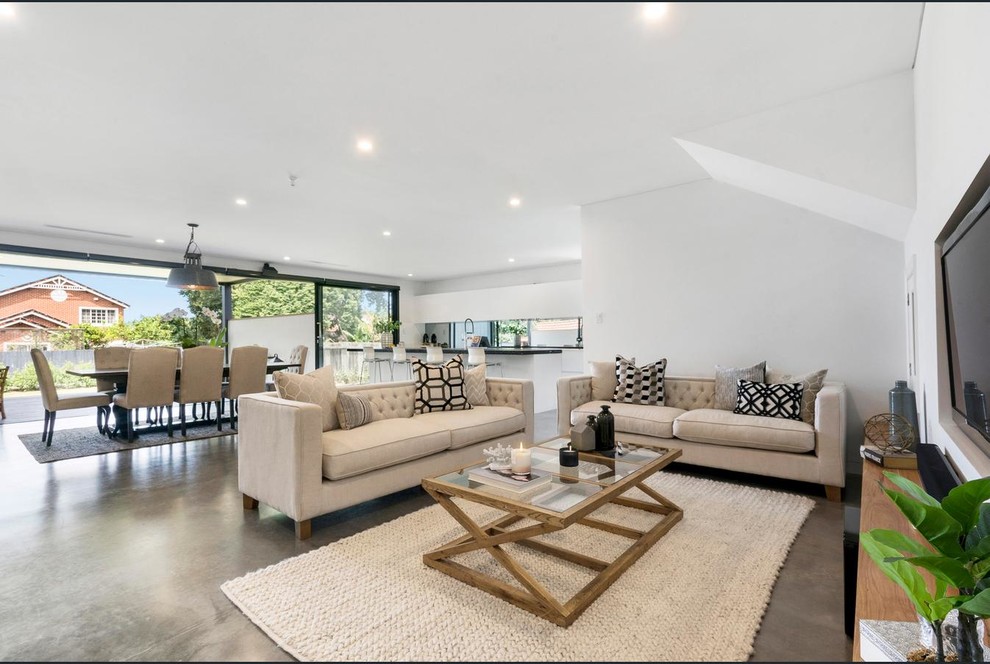Design ideas for a mid-sized contemporary open concept living room in Sydney with white walls, concrete floors, a built-in media wall and grey floor.