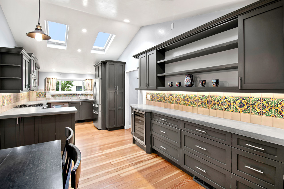 Design ideas for a small traditional u-shaped kitchen in San Francisco with an undermount sink, shaker cabinets, distressed cabinets, concrete benchtops, ceramic splashback, stainless steel appliances, medium hardwood floors, brown floor and grey benchtop.