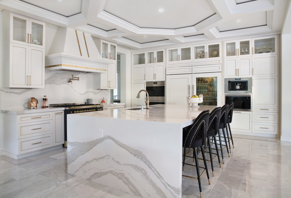 Inspiration for a mid-sized transitional l-shaped open plan kitchen in Orange County with an undermount sink, shaker cabinets, white cabinets, quartz benchtops, white splashback, marble splashback, stainless steel appliances, marble floors, with island, grey floor and white benchtop.