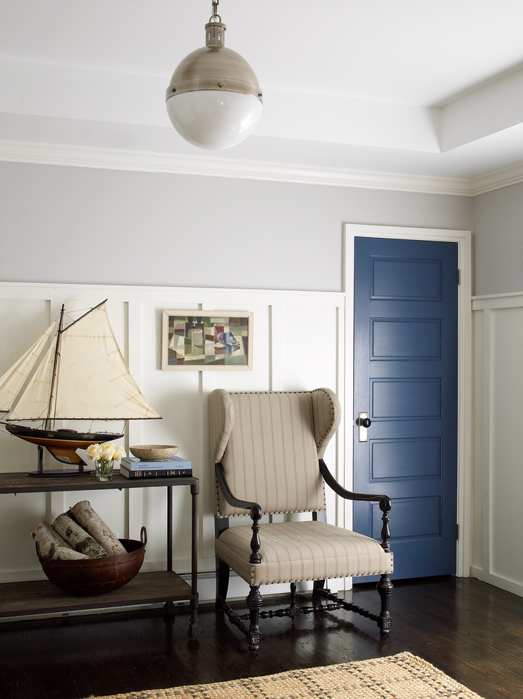 Design ideas for a beach style entryway in New York with a blue front door and black floor.