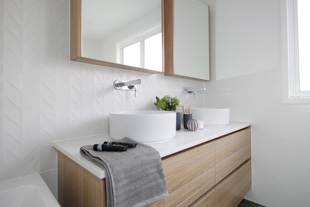 Inspiration for a mid-sized contemporary master bathroom in Brisbane with flat-panel cabinets, light wood cabinets, a freestanding tub, an open shower, a two-piece toilet, white tile, ceramic tile, white walls, porcelain floors, a vessel sink, engineered quartz benchtops, grey floor, an open shower and white benchtops.