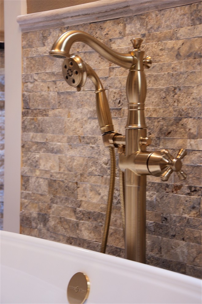 Inspiration for a large contemporary master bathroom in Austin with beaded inset cabinets, dark wood cabinets, a freestanding tub, an open shower, a bidet, beige tile, beige walls, ceramic floors, a drop-in sink and granite benchtops.