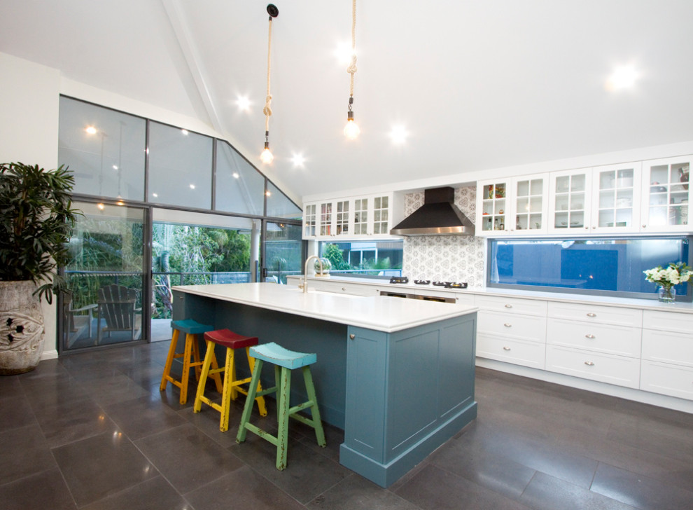 This is an example of a large traditional open plan kitchen in Brisbane with shaker cabinets, quartz benchtops and ceramic splashback.
