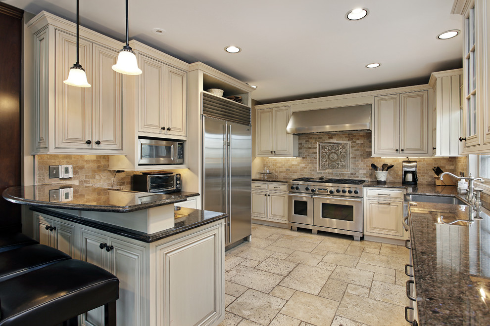 Large traditional galley separate kitchen in Los Angeles with a drop-in sink, beaded inset cabinets, white cabinets, marble benchtops, stainless steel appliances, ceramic floors, ceramic splashback, beige splashback and no island.