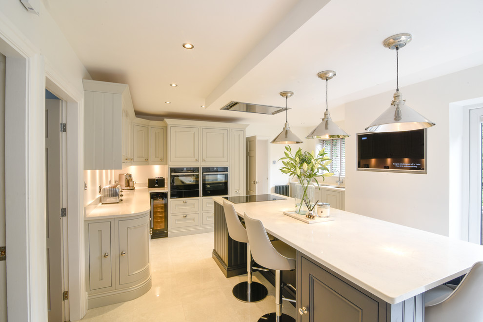 Design ideas for a large transitional u-shaped eat-in kitchen in Manchester with a drop-in sink, shaker cabinets, grey cabinets, granite benchtops, panelled appliances, porcelain floors, with island, white floor and white benchtop.