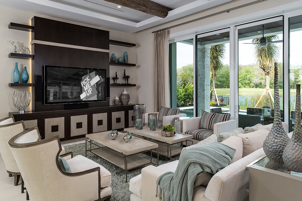 This is an example of a mid-sized transitional family room in Miami with beige walls, marble floors and a wall-mounted tv.