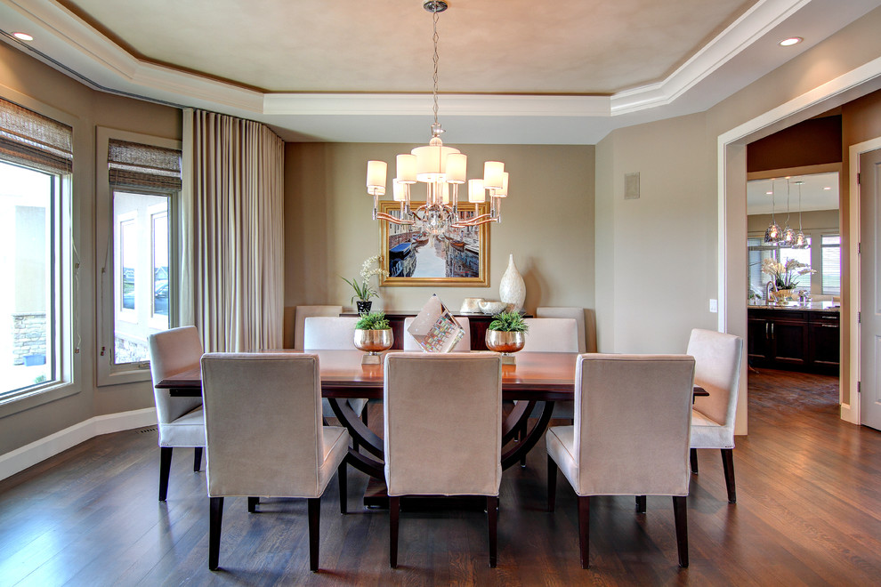 Inspiration for a large traditional separate dining room in Calgary with beige walls, dark hardwood floors and no fireplace.